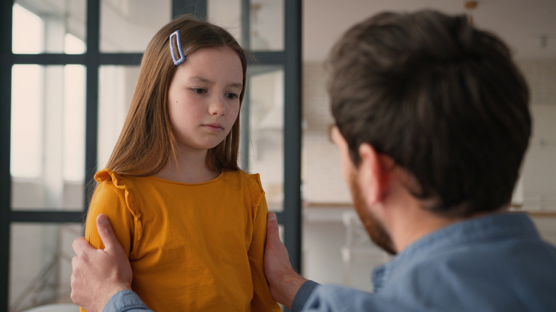 Caring Caucasian guy man parent touching offended frustrated little girl schoolgirl child quarrel dad male supporting frustrated daughter at home father comfort little kid family problem fatherhood